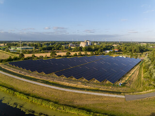 drone shot of a solar park on a river in the countryside