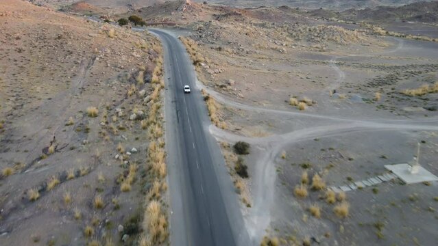 Aerial View Of Car Driving Along RCD Road Through Balochistan. Dolly Back