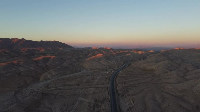 Aerial View Of Sunset On Horizon Over RCD Road Through Remote Balochistan Dramatic Landscape. Dolly Forward 
