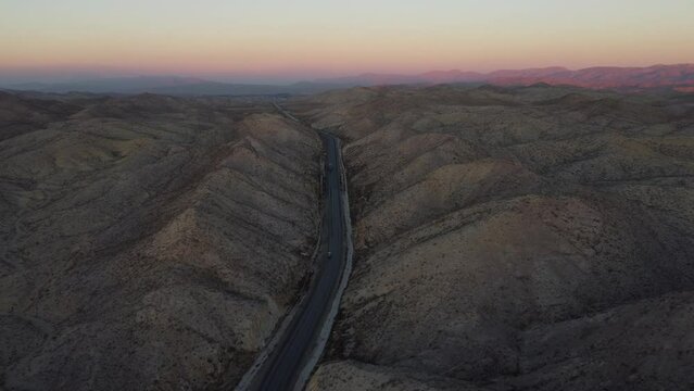 Aerial View Of Purple Sky Sunset On Horizon Over RCD Road Through Remote Balochistan