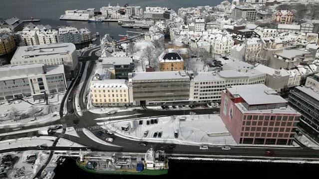 Quick flyover of the center of Ålesund which ends with that beautiful and magnificent image of the center core and the mountain Aksla with the stairs leading to the top. A big snowfall has arrived