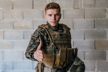 A soldier in uniform stands in front of a stone wall with an outstretched hand. The concept of...