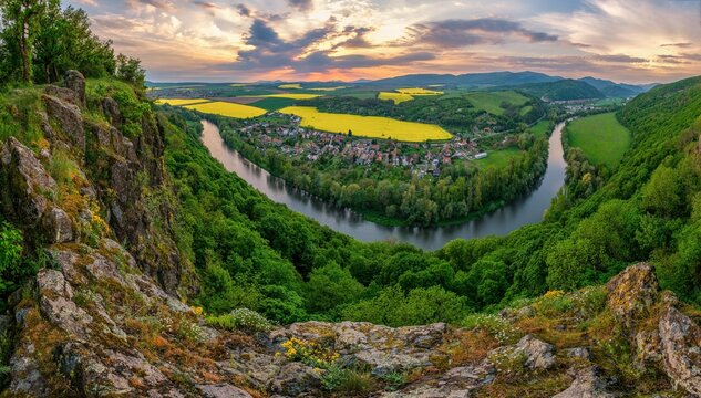 Spring sunset over meander of river Hron in Slovakia from extinct volcano, biotope of rare plants and flowers. Discover the spring beauty of the mountains and rivers.