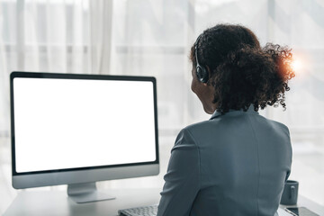 close up call center operator in wireless headset talking with customer, woman in headphones with...