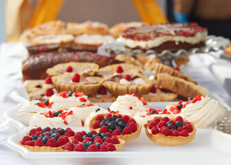 Fruit tarts, pavlova, brownies and other tasty desserts and delicacies on sale at the confectionery stand at the Prague Farmers Street Food Market