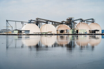 Industrial harbour during snowy winter, buildings in foreground