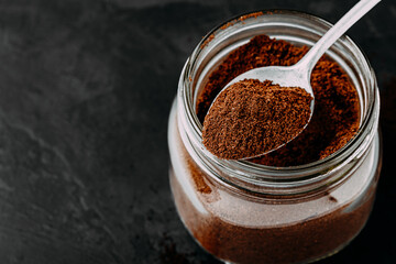 Ground coffee. Ground Coffee in jar on dark background