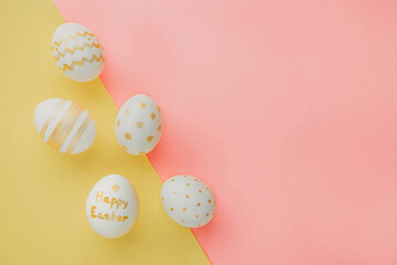 Fototapeta na wymiar Easter background. Easter golden decorated eggs on mixed color background. Minimal easter concept. Flat Lay of Golden Easter Eggs