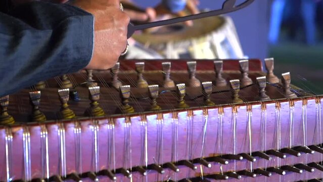playing song in a dulcimer musical instrument closeup view