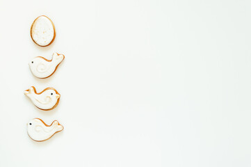 Easter gingerbread in the shape of a bird and a rabbit on a white background. High quality photo. space for text. banner