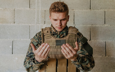 A Muslim soldier of the special forces prays to God by raising his hands and starts a prayer