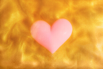 pink heart on Yellow Golden Shiny Background. Paints, Acrylic, Glitter in Water. pink heart in...