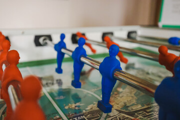 Foosball table soccer close up of red and blue characters