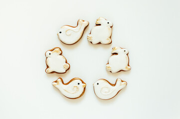 Easter gingerbread in the shape of a bird and a rabbit on a white background. High quality photo. space for text. banner