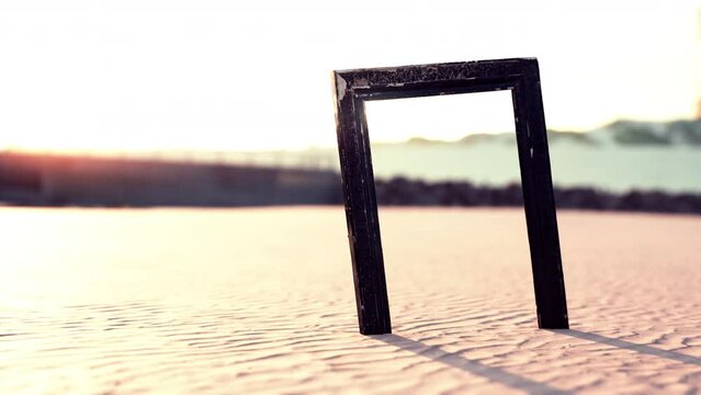 Empty wooden picture frame on the beach sand