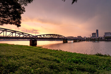 Fototapeta premium Dawn at Truong Tien Bridge. This is a Gothic architectural bridge spanning the Perfume river from the 18th century designed by Gustave Eiffel in Hue, Vietnam