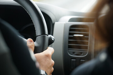 Driving a car - close-up on steering wheel