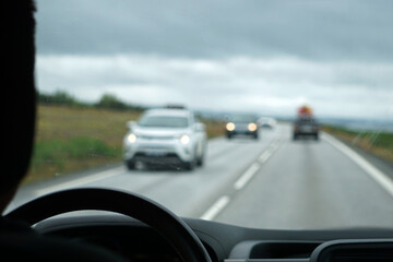 Fototapeta na wymiar Driving a car - perspective of a driver - bokeh effect
