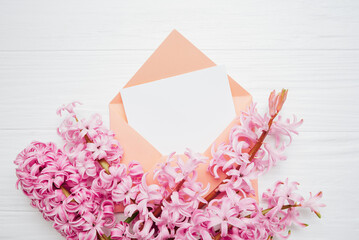 8 March greeting card. mother's day, International Women's Day congratulate Holiday background celebration concept. Pink hyacinth bouquet and envelope on white background. Mockup copy space