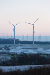 Wind turbines generate energy power electricity during the evening. winter landscape, pastel, wind turbines, clean energy