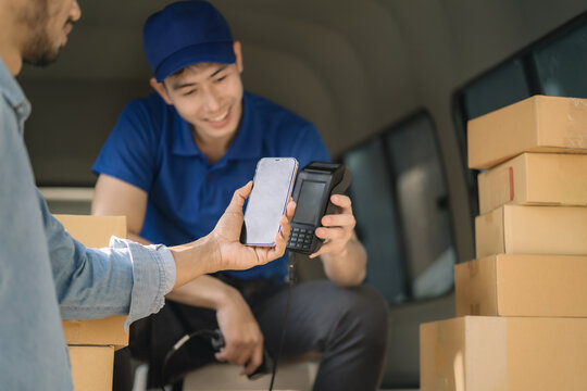 Asian delivery man, Hand using smart phone to scan QR code on tag, concept of parcel delivery, Qr code payment concept.