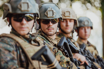 Soldier fighters standing together with guns. Group portrait of US army elite members, private...