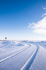 Fototapeta na wymiar Vehicle Tyre Tracks In The Snow Around Utsjoki, Finland