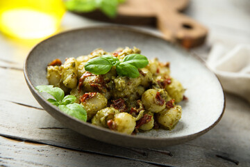 Homemade potato gnocchi with pesto and tomatoes
