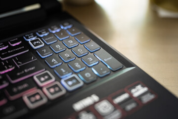 Color backlit keyboard close up. Gaming laptop.