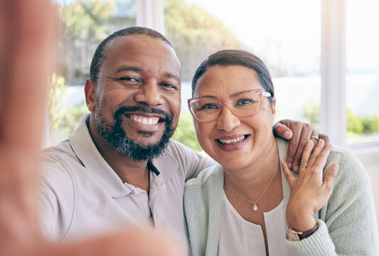 Happy, mature and portrait of an interracial couple with a selfie for a memory, together and relationship. Smile, love and a black man with a woman taking a photo, looking and joyful at home