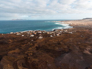 Aerial photos of Calhau, a village located near an inactive volcano in Sao Vicente Island, Cabo Verde, offer a unique perspective of the towering volcanic landscape, rugged terrain, and vibrant coasta