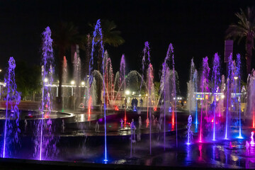 Enchanting grandiose musical performance - water and light show of a musical fountain on the embankment, in the center of the city of Eilat in southern Israel
