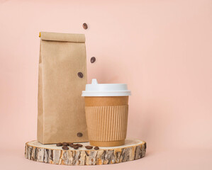 Disposable paper cup and a paper bag on pastel background