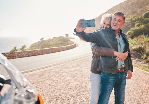 Mountain, bikers and couple taking a selfie together while on an adventure, vacation or weekend trip. Freedom, nature and senior man and woman in retirement taking a picture while on a motorbike ride