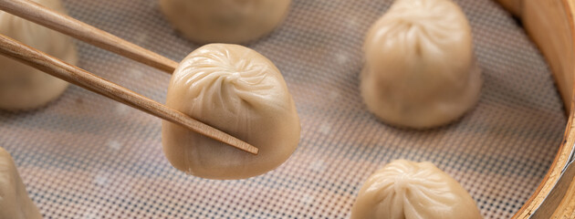 Steamed pork soup dumplings named Xiao long bao in Taiwan.