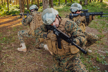 Fototapeta premium Soldier fighters standing together with guns. Group portrait of US army elite members, private military company servicemen, anti terrorist squad