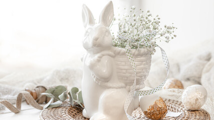 Fototapeta na wymiar Easter composition with a ceramic hare and gypsophila flowers.