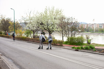 Fototapeta premium young couple from behind riding in roller skates on the street