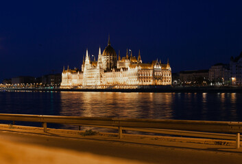 View on Budapest Parliament building across the river at night. Illuminated landmark.
