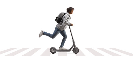 Full length profile shot of an african american male student riding an electirc scooter on e pedestrian crossing © Ljupco Smokovski