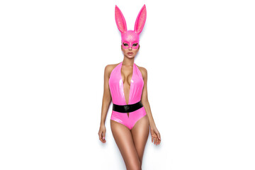 Sexy blonde woman is posing in latex Easter bunny costume and pink bunny mask on white background....