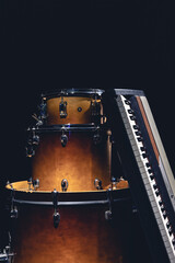 Obraz na płótnie Canvas Drums and musical keys on a black background isolated.