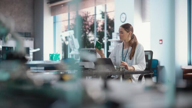 Portrait of Professional Female Scientist Working in Industrial Lab Using Laptop Computer. Successful Engineer Checking and Monitoring Production Quality, Analysing Data Using Technology