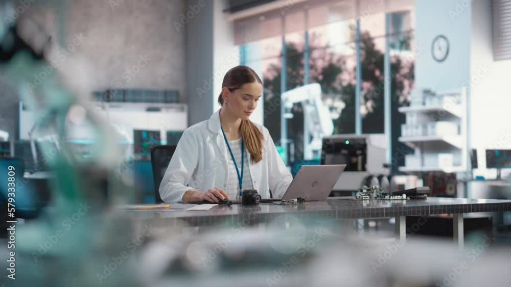Poster Portrait of Professional Female Scientist Working in Industrial Lab Using Laptop Computer. Successful Project Manager Making Strategy Plans for Industrial Production Company, Using Technology