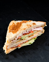 Breakfast toasted bread with chicken ham, lettuce, cheese and tomatoes.