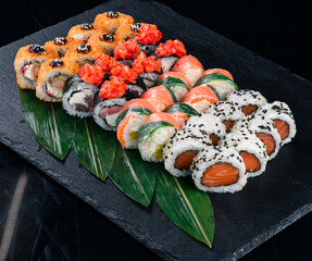 Set of maki sushi rolls with tuna, sea bass, salmon, cream cheese, rice paper, shrimp and sweet pepper.