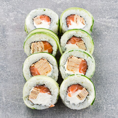 Maki sushi rolls with salmon, tamago omelet, cucumber and cream cheese.
