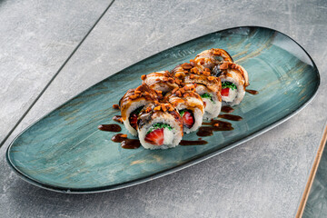 Set of maki sushi rolls with smoked eel, strawberry, cream cheese, seaweed, nuts and sauce. - 579335682