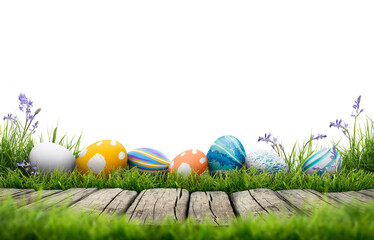 A collection of painted easter eggs celebrating a Happy Easter template with a wooden bench to place products with green grass and transparent background - obrazy, fototapety, plakaty