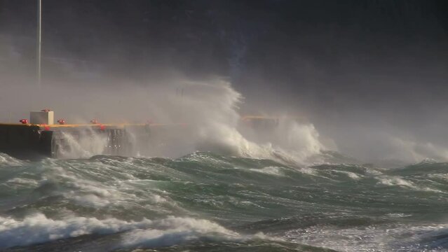 Powerful waves hitting docks Akureyri Iceland winter storm